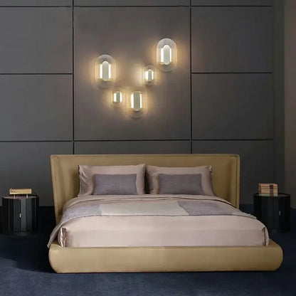 Modern circular brushed metallic wall lamp with warm glowing frosted glass shades for elegant glass wall décorbites decor