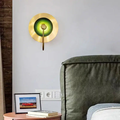 A modern wall lamp with a circular green copper frame and textured glass shade ideal for living room decorbites circular green