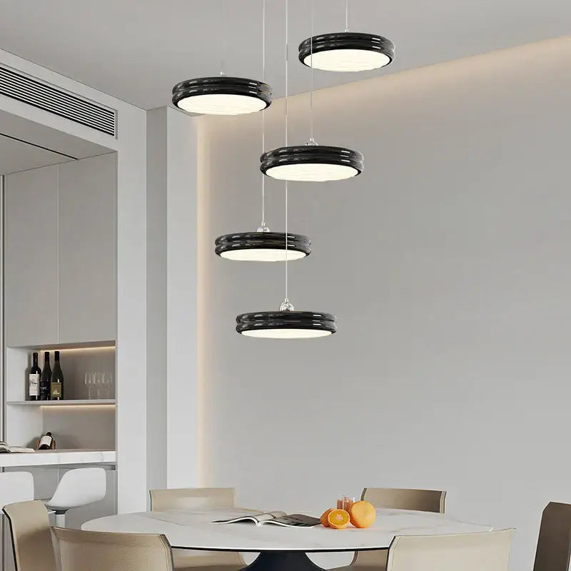 Modern chandelier pendant featuring sleek black circular lights in descending tiers for dining room decorbites circular modern design