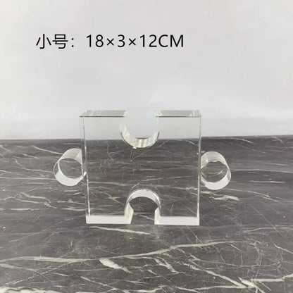 Modern clear acrylic crystal geometric puzzle bookends featuring clear acrylic puzzle piece shape with three circular cutouts