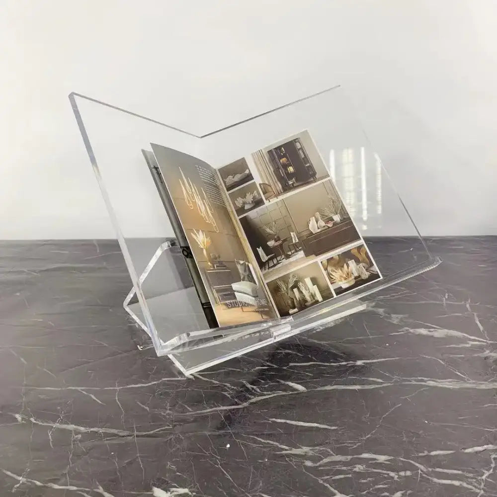 Modern clear acrylic geometric magazine rack holding an open magazine for office desktop storage by decorbites