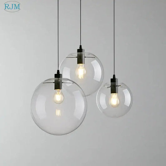 Modern clear bubble glass ball pendant light with black metal fixtures and exposed filament bulbs for kitchen decorbites pendant light