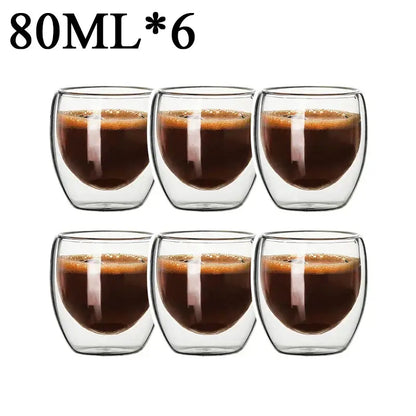 Set of six 80ml modern clear double wall borosilicate glass espresso cups filled with dark espresso and crema layer