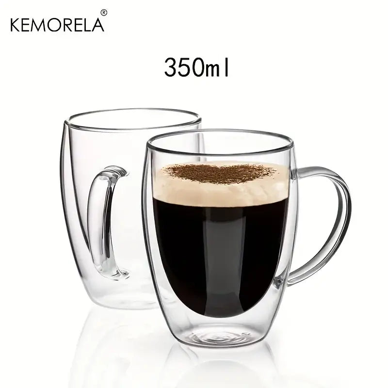 Modern clear double wall glass coffee mug with handle holding dark espresso topped with creamy foam for kitchen use
