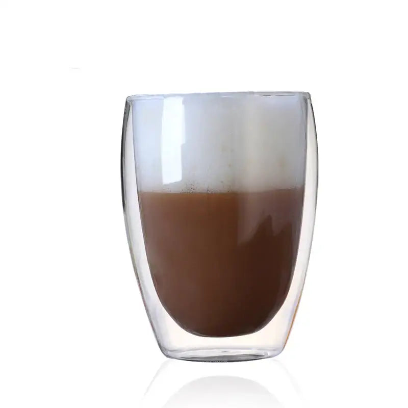 Modern clear double wall glass cup filled with layered coffee drink from a dining room tumbler set