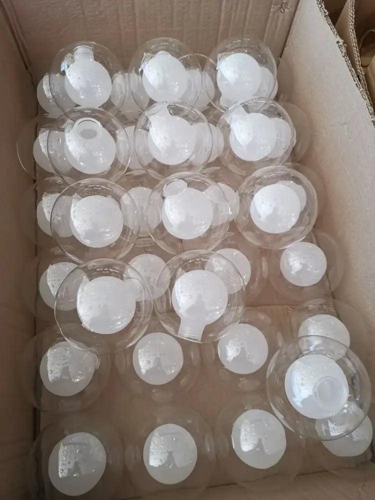 Modern clear and frosted glass ball pendant light featuring clear glass globe ornaments with white frosted caps
