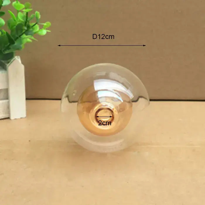 Modern clear glass shade cover replacement with golden filament bulb and edison-style design for living room use