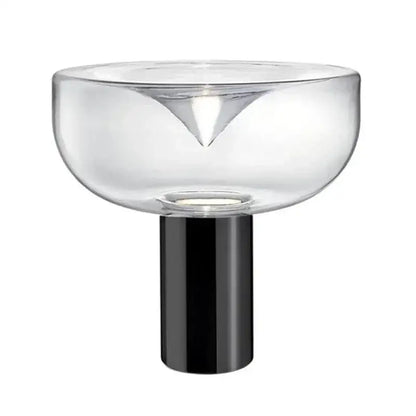 Modern clear glass aella table lamp with sleek black cylindrical base and triangular cutout for bedroom or office decorbites aella