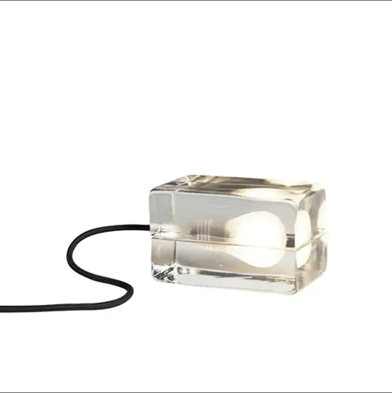 Modern clear glass cube led table lamp with visible bulb and black cord for bedroom nightlight use