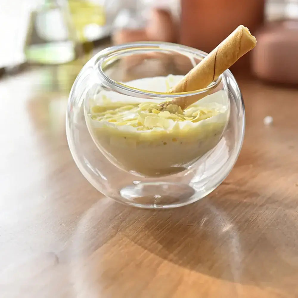 A modern clear decorbites glass cup set featuring a transparent glass bowl with creamy custard and coconut topping