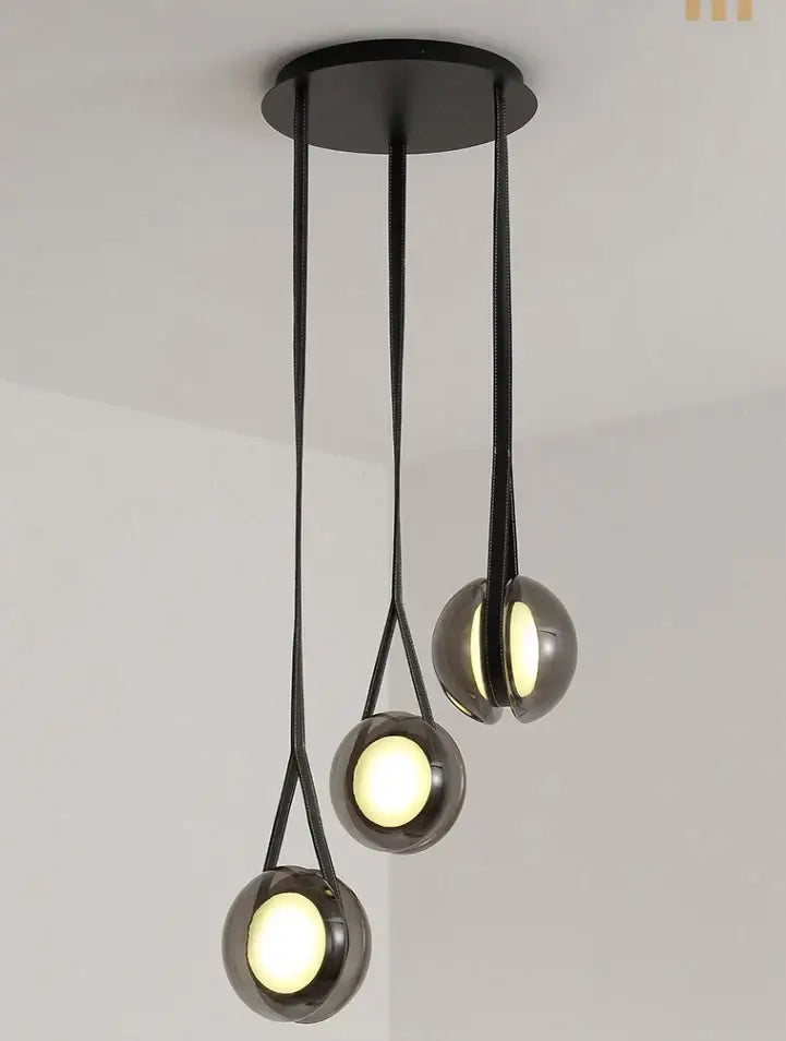 Modern clear glass designer pendant lights feature black spherical glass bulbs suspended by sleek cords for bedroom decorbites pendant lights