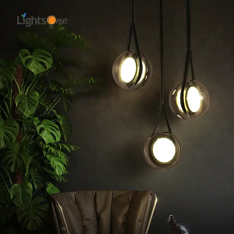 Three modern clear glass pendant lights with black fabric cords from decorbites designer pendant lights collection