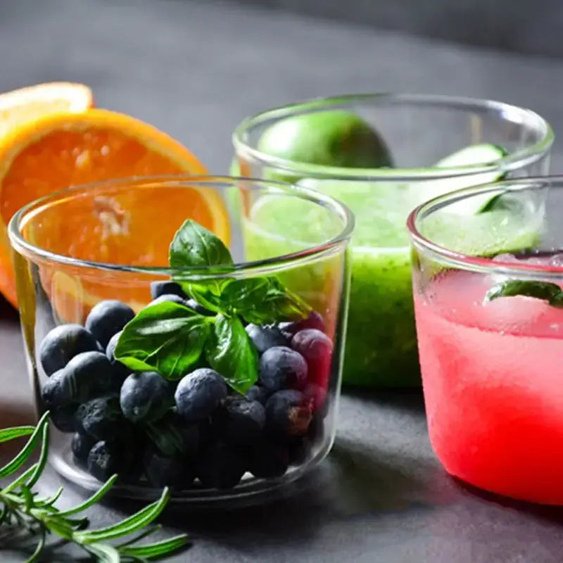 Modern clear glass dessert cup set with a clear glass dessert cup filled with fresh blueberries and green basil