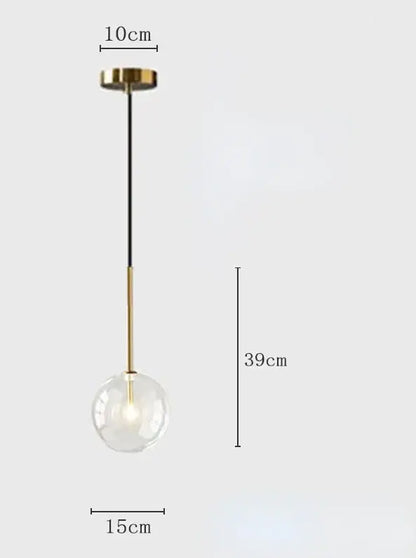 Modern pendant light with gold-toned metal fixture and transparent clear glass globe suspended by black cord