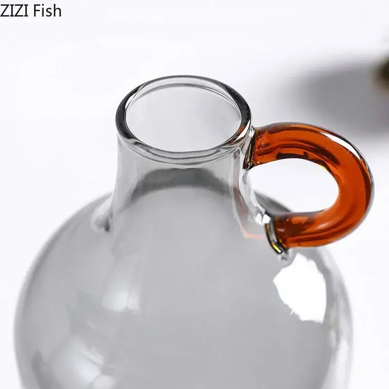Modern clear glass vase with a curved amber handle perfect for living room decor by decorbites clear glass collection