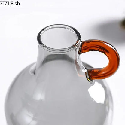 Modern clear glass vase with a curved amber handle perfect for living room decor by decorbites clear glass collection