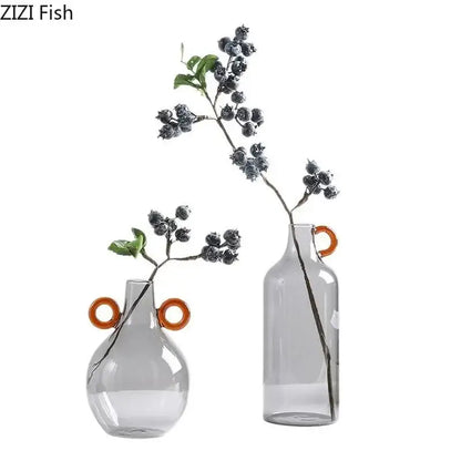 Two translucent gray clear glass vases with orange circular handles modern clear glass vase decor for living room