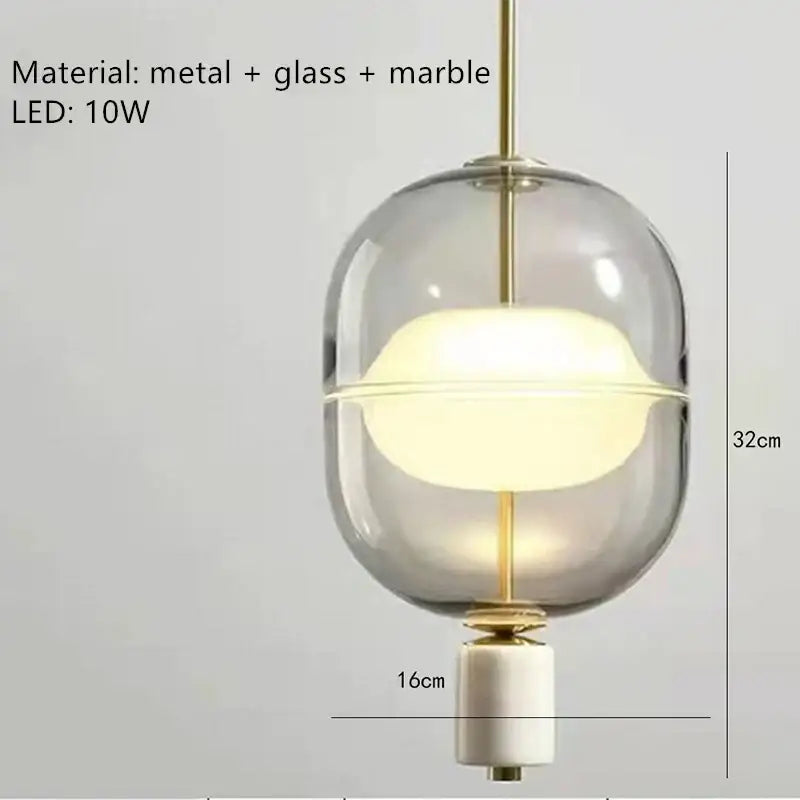 Modern clear gray amber pendant light with gold-toned metal accents and white marble base for dining room decorbites clear gray