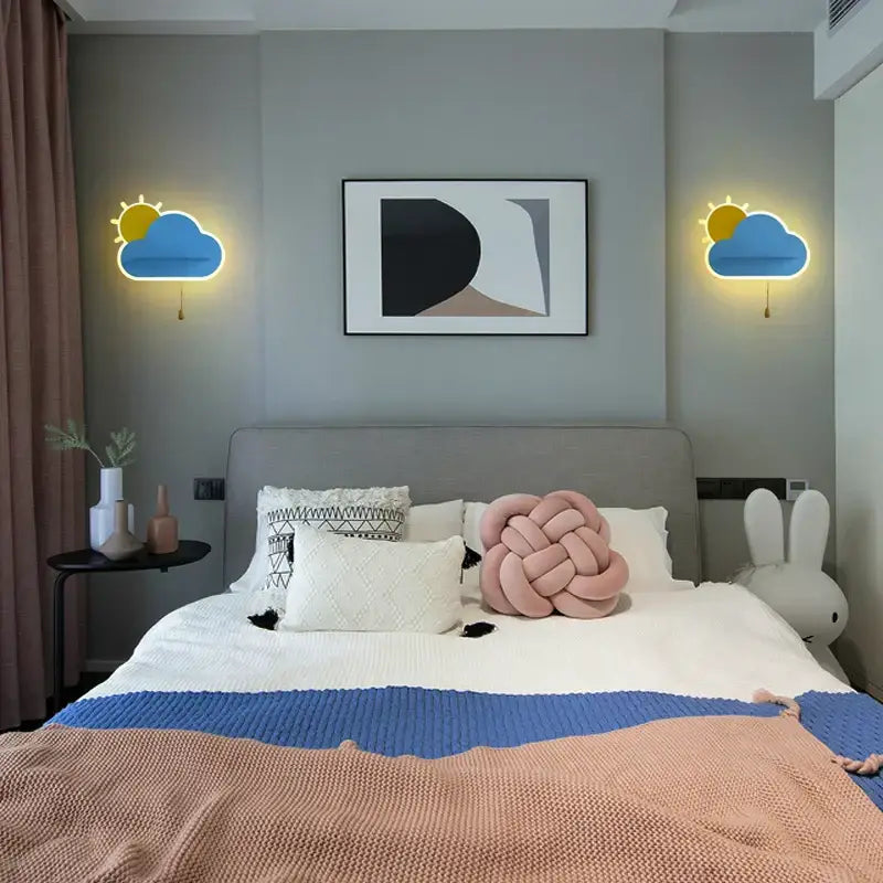 Pastel pink knotted knit pillow with soft textured surface paired with modern decorbites cloud wall lamps for childrens bedroom
