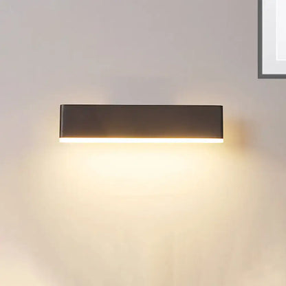 Modern coffee white rectangular sconce with matte black finish emitting warm ambient light and maximum bulb wattage for bedroom use