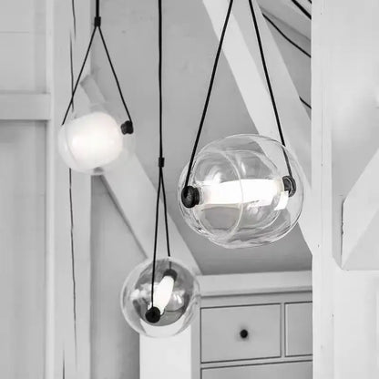 Modern colorful czech glass capsule pendant light with clear glass globe and black cords for dining room use