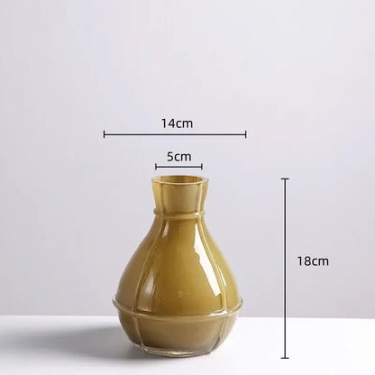 A sleek olive green ceramic vase with glossy finish and geometric ridges in a decorbites colorful geometric glass set
