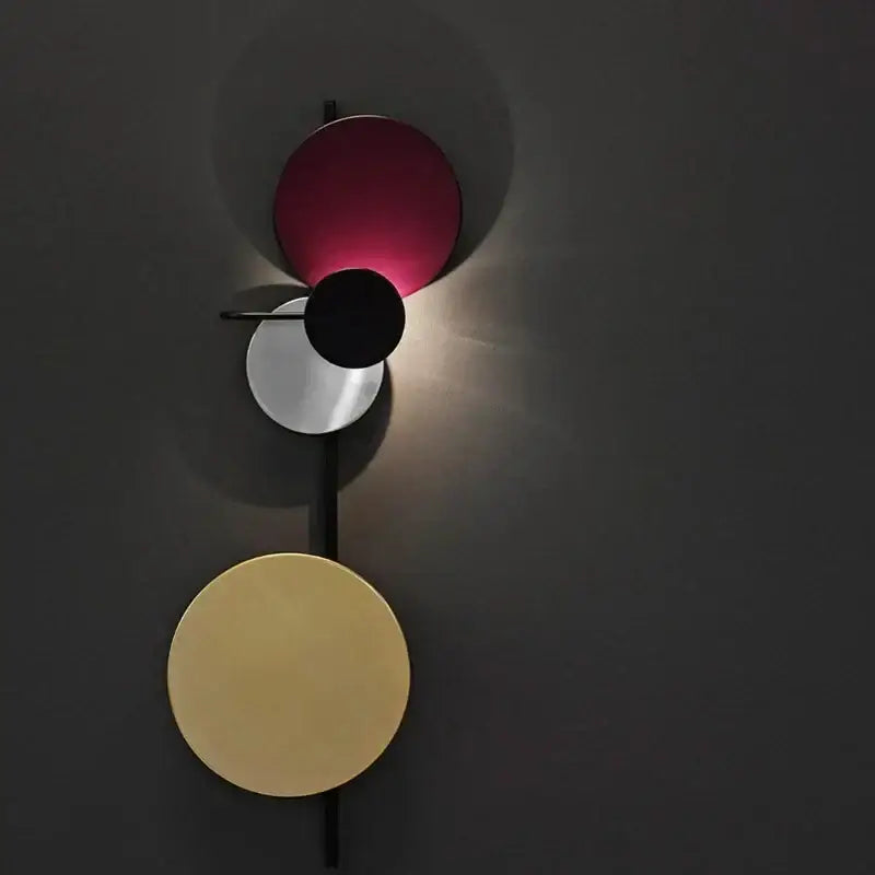 Modern colorful geometric led wall lamp with stacked circular discs in matte burgundy brushed silver and gold finishes