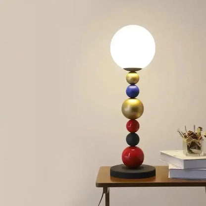 Modern colorful glass ball floor lamp with glossy gold, blue, red, black spheres and white globe shade for living room