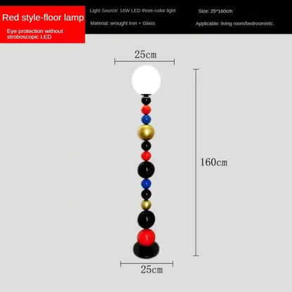 Modern colorful glass ball floor lamp with a slender red base and white spherical light for living room use
