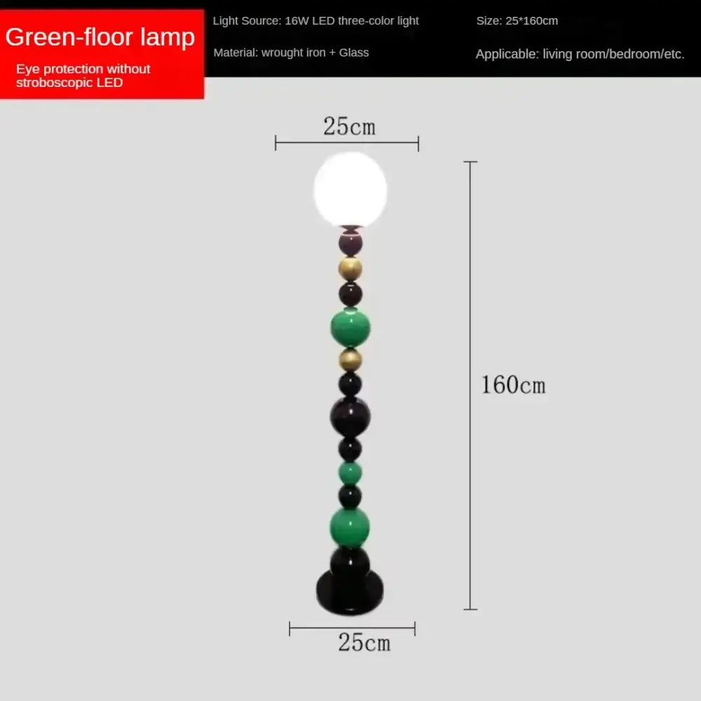 A tall floor lamp with colorful glass ball green and black orbs and gold-toned metal beads for living room