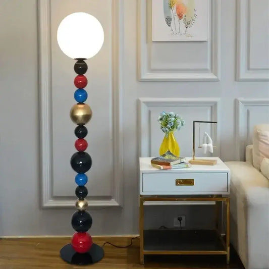 Modern colorful glass ball floor lamp with stacked red blue black and gold spherical bulbs for living room lighting