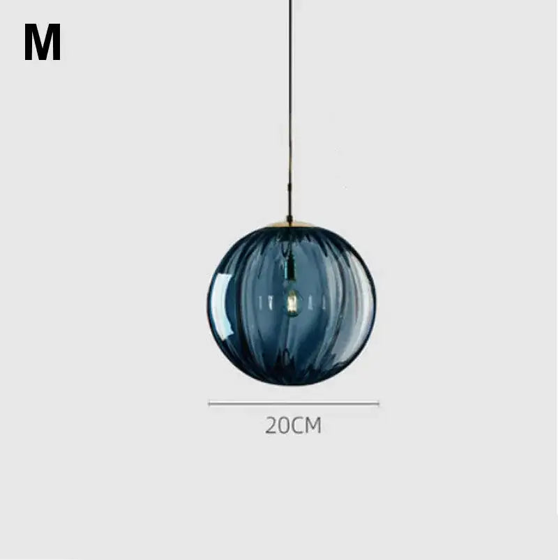 A sleek 20cm pendant light with deep blue ribbed glass ball lustre and brass finish for modern kitchen decorbites