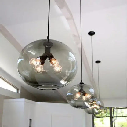 Sleek modern colorful decorbites glass bowl pendant lights with smoked glass and exposed filament bulbs for kitchen decor
