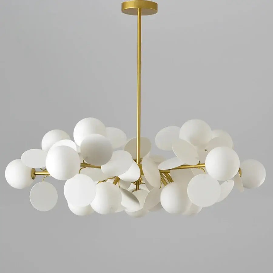 Gold-toned decorbites branch chandelier with frosted white glass shades in a modern cloud-like cluster for living room