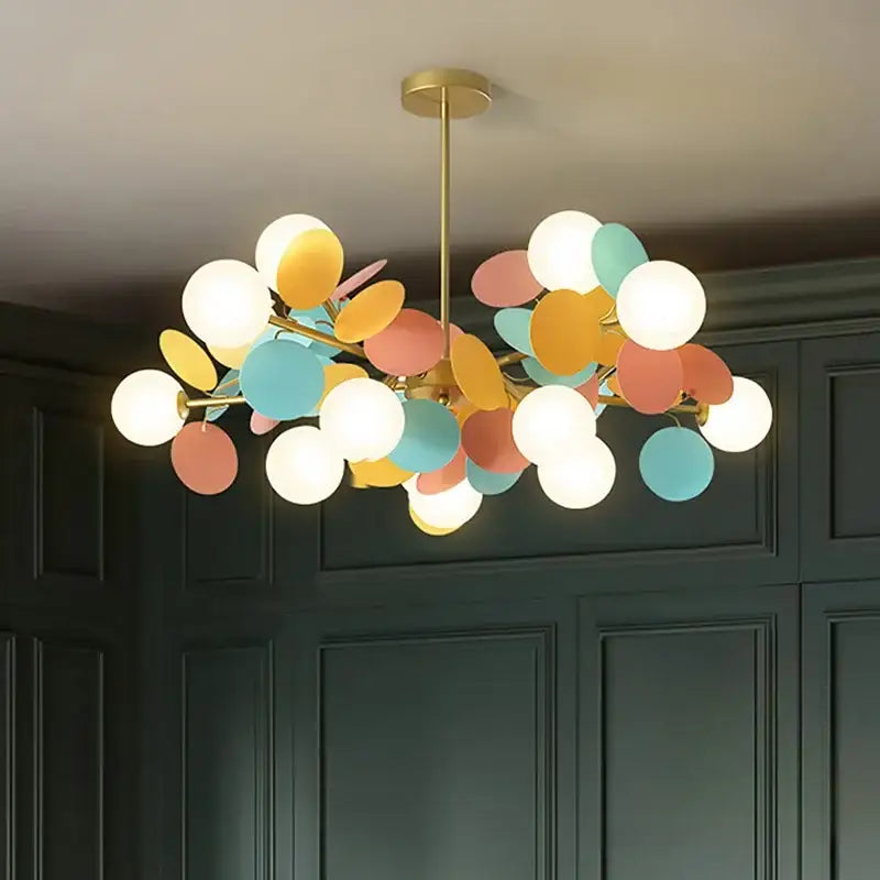 A modern decorbites branch chandelier with brass finish and pastel colorful glass shades for living room decor