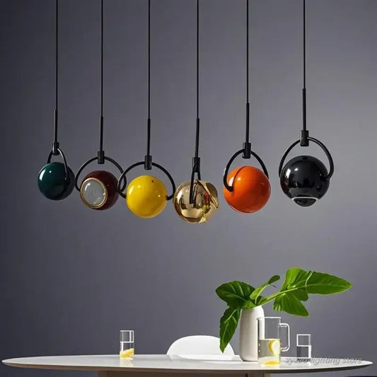 Set of five modern colorful glass mini pendant lights with polished steel accents for kitchen lighting with black cords