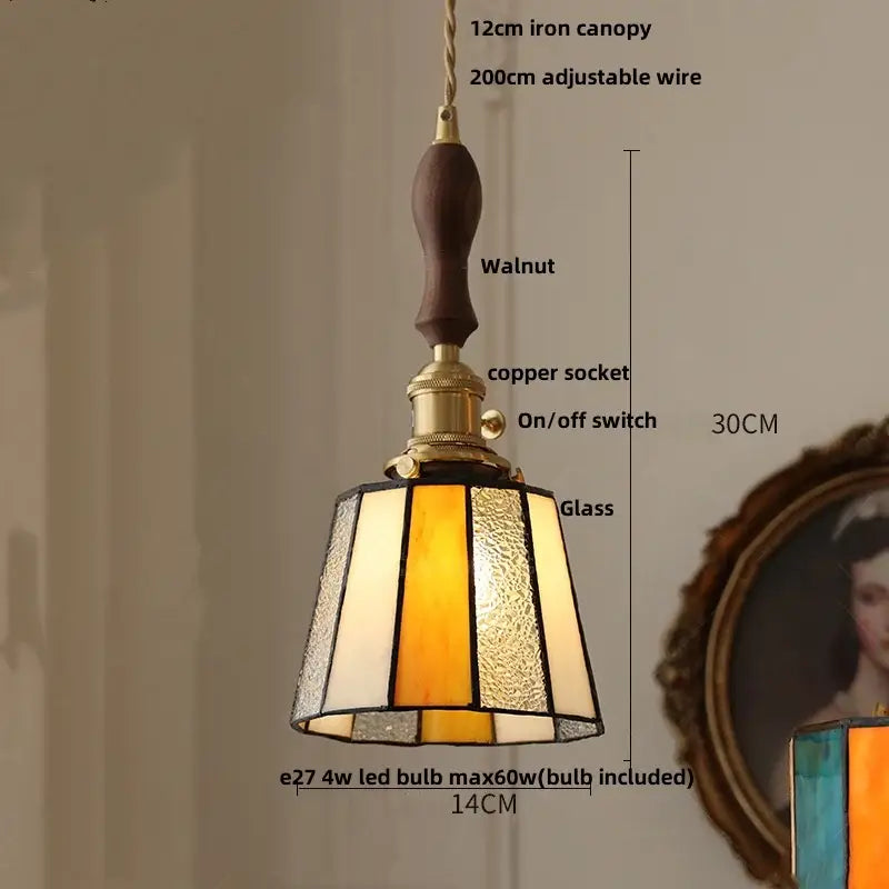 A warm-toned pendant light with brass accents and colorful led glass amber and cream panels for modern decorbites decor