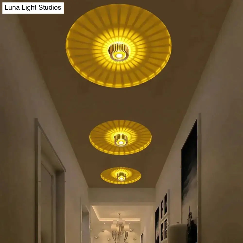 Three golden sunburst decorbites™ recessed ceiling lights with metallic fixtures for indoor gallery and corridor use