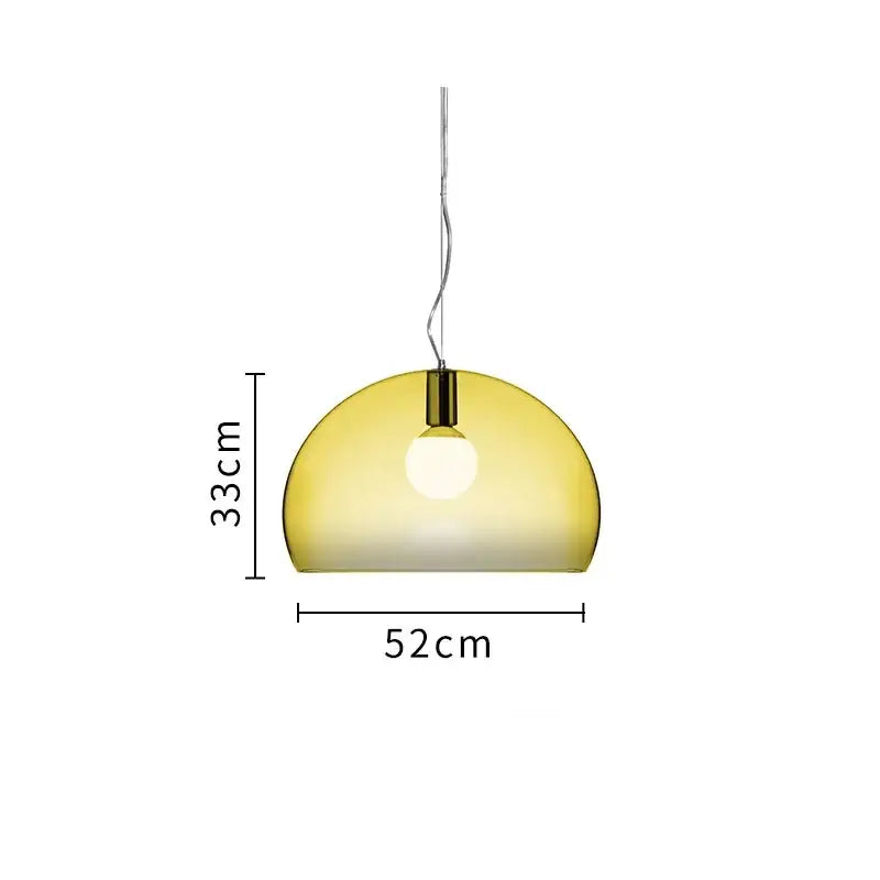 A sleek semi-transparent amber glass pendant lamp with polished brass fixture in a modern dining room decorbites colorful hanging light