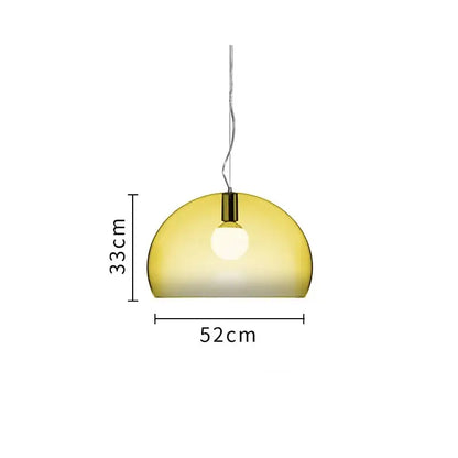 A sleek semi-transparent amber glass pendant lamp with polished brass fixture in a modern dining room decorbites colorful hanging light