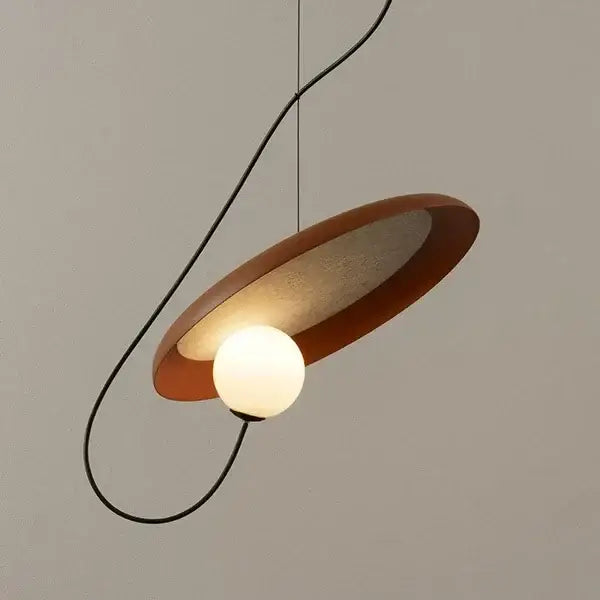 Modern copper and black grid color led pendant light with warm-toned matte circular shade and glowing bulb decorbites grid color