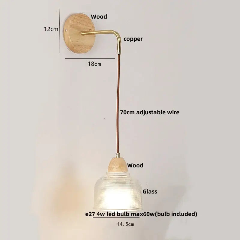 Modern copper and wood wall sconce with clear glass ribbed shade and pull chain switch mounted on natural wood base