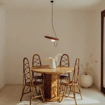 A minimalist pendant light with a warm wooden shade and black cord in modern copper decorbites grid color led style