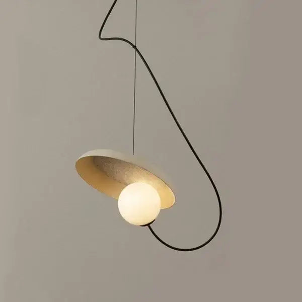 Modern pendant light with matte white shade, gold lining, and black curved cord for dining room decorbites grid color led