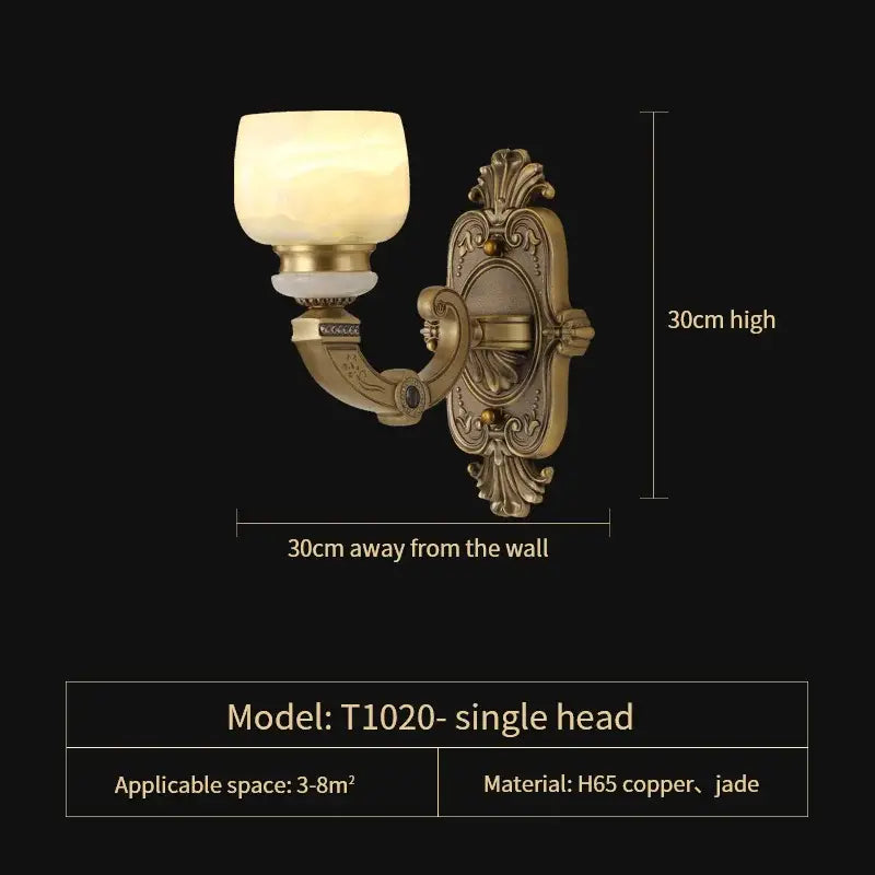 Antique brass-finished wall sconce with ornate scrollwork and frosted glass shade for copper jade chandelier lighting