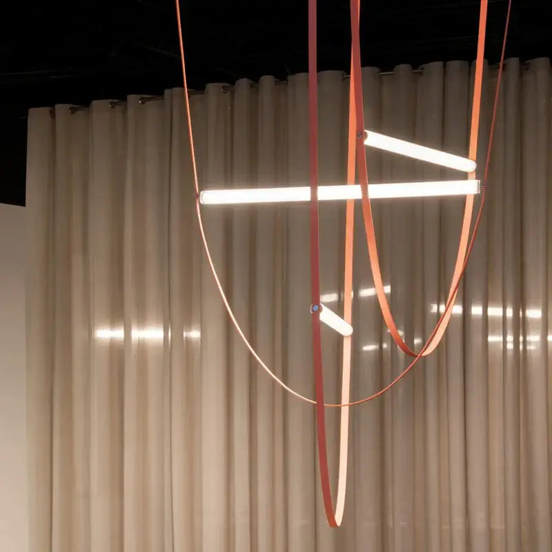 Modern copper leather bell pendant light with sleek orange straps and illuminated white LED bars for pendant light decorbites bell pendant