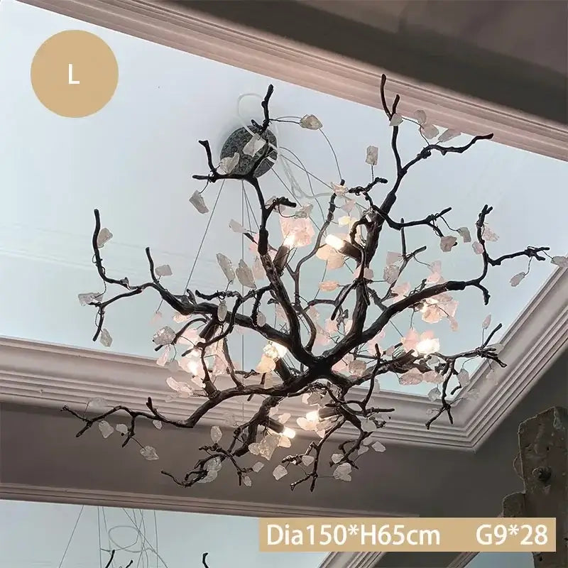 Elegant black copper led branch chandelier with translucent pink and clear crystal leaves illuminated warm light decorbites copper led