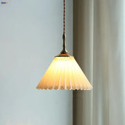 Modern copper led pendant lamp featuring warm-toned pleated glass and brass fixture with twisted cord by decorbites copper led