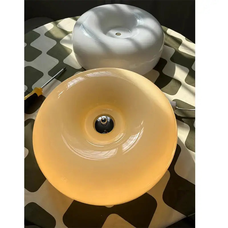 Modern cream bauhaus style ceiling lamp with glossy acrylic donut pendant and central metallic fixture for bedroom decorbites cream bauhaus