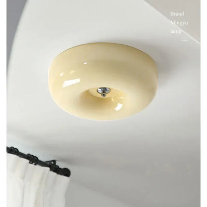 Modern cream bauhaus style ceiling lamp with glossy ceramic finish and metallic center fixture for bedroom decorbites decor